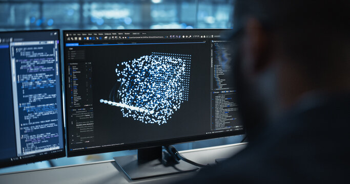 Male Software Engineer Focused on Working on a Machine Learning Model Displayed Across Three Monitors. Black Specialist Analyzing Data Outputs and Tweaking Parameters in Real Time