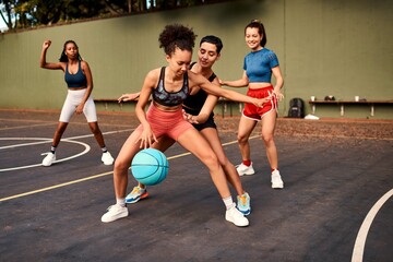 Fitness, basketball and women playing game together for competition, challenge and fun on playground. Outdoor, performance and girl friends on court with ball, exercise and teamwork at sports club.
