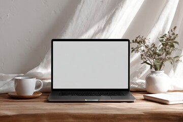 Fototapeta premium Minimalist workspace with laptop, cup, and decorative elements