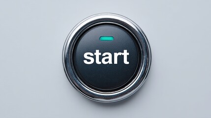 Black round start button with chrome frame and glowing green indicator on light background
