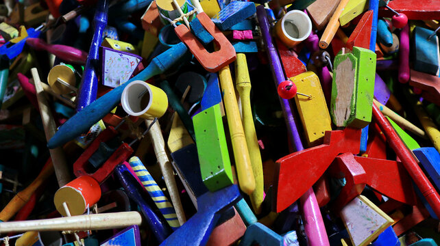 Pile of colorful wooden toys scattered randomly on a surface, creating a playful and chaotic scene with a vintage, handcrafted feel.