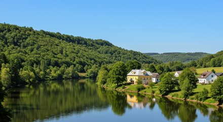 Idyllic rural landscape with houses on a lake shore in summer