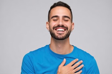 Fototapeta premium Joyful man laughing heartily indoor studio portrait photography neutral background close-up happiness concept