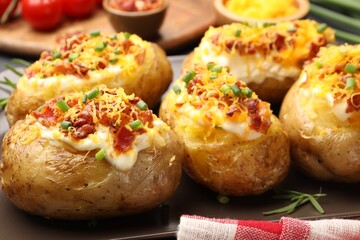 Tasty stuffed baked potatoes on table, closeup