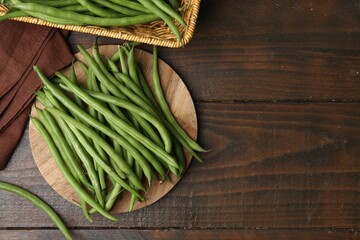 Fresh green bean pods on wooden table, flat lay. Space for text