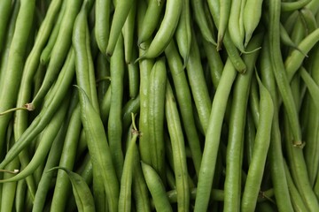 Fresh green bean pods as background, closeup