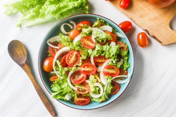 tomato salad with mixed onions and lettuce on the table