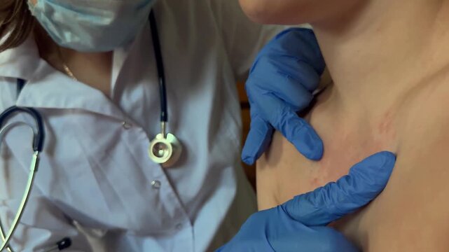 The doctor is assessing the boy for allergic skin reactions.