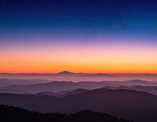 Mountain silhouettes at sunrise/sunset with layers of hazy mist