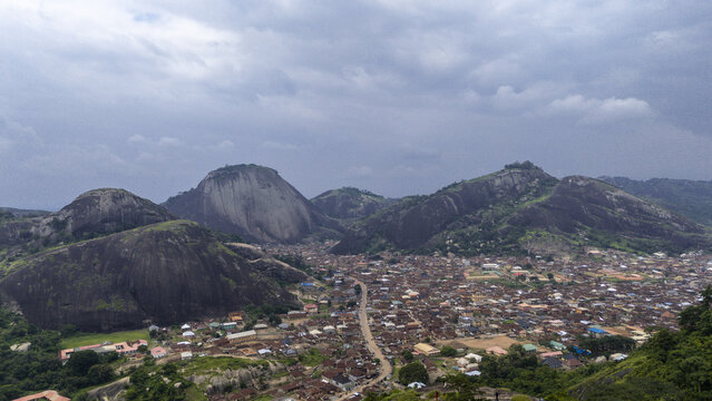 Aerial view of the dramatic Idanre Hills looming over the town below, shrouded in a soft, moody light, Ida really, Ondo, Nigeria.