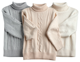 Three folded turtleneck sweaters in muted tones