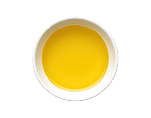 Top-down view of a small, round, white bowl filled with a bright yellow liquid