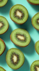 Top view of kiwi slices on a turquoise background, highlighting the vibrant green color and unique texture, ideal for food photography and healthy lifestyle themes