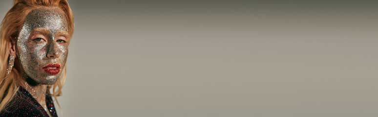 Young woman shines with sparkling glitter in studio glamour shoot