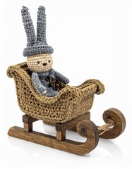Crocheted Bunny Figure in Brown and Gray Knitted Sleigh on White Backdrop for Christmas Decoration and Craft