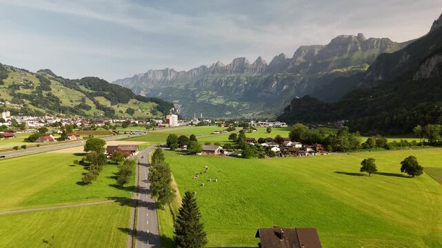 Scenic Aerial View of a Valley with Green Fields and Mountain Landscape in Switzerland near Flums, Berschis, and Walenstadt in the Canton of St. Gallen &ndash; Drone Footage