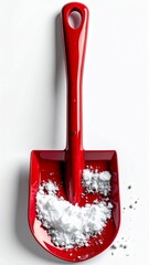 Bright Red Toy Shovel Filled with White Granular Material Against White Backdrop