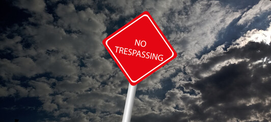 No trespassing attention sign on background 