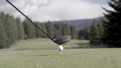 Iron club hitting golf ball in beautiful nature