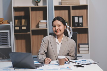 Fototapeta premium Asian businesswoman working happily about the success of the company,doing planning analyzing the financial report, business plan investment, finance analysis concept.