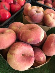 Fresh Flat Donut Peaches in a Basket – Summer Farmers Market Fruit. mediterranean fruits. Prunus persica var. close up. platycarpa isolated.
