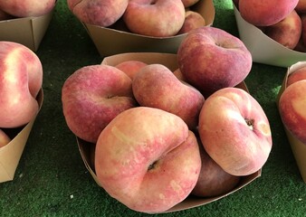 Fresh Flat Donut Peaches in a Basket – Summer Farmers Market Fruit. mediterranean fruits. Prunus persica var. close up. platycarpa isolated.