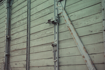 Close up of wooden freight wagon wall with metal reinforcement beams