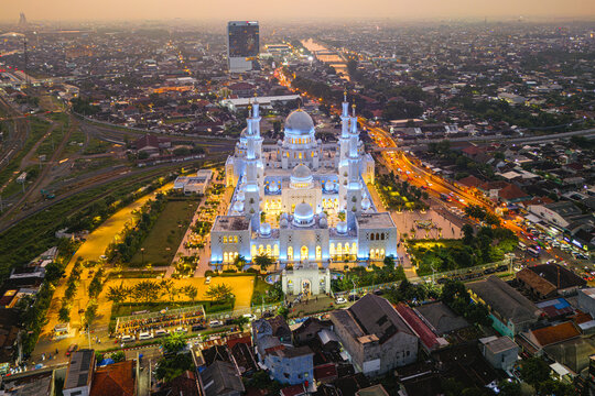 Aerial view of the majestic Masjid Raya Sheikh Zayed Solo mosque illuminated against the soft glow of dusk, Surakarta, Central Java, Indonesia.
