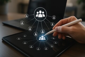 Stylus interacting with team network diagram on tablet representing people and connection icons
