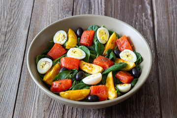 Salad with salmon, spinach, baked potatoes, olives and eggs. Healthy eating. Diet.
