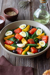 Salad with salmon, spinach, baked potatoes, olives and eggs. Healthy eating. Diet.