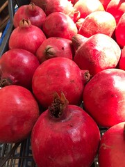 Fresh Pomegranates and Seeds Displayed at Market – Juicy Red Fruit. Punica granatum isolated. mediterranean fruits close up.