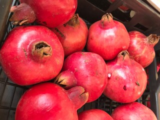 Fresh Pomegranates and Seeds Displayed at Market – Juicy Red Fruit. Punica granatum isolated. mediterranean fruits close up.