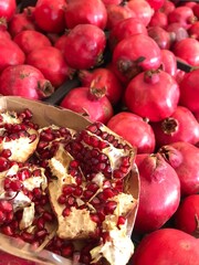 Fresh Pomegranates and Seeds Displayed at Market – Juicy Red Fruit. Punica granatum isolated. mediterranean fruits close up.