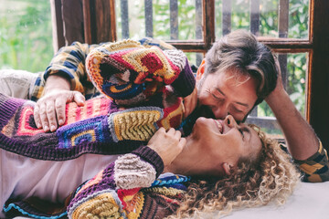 Loving mature couple relaxing at home, sharing affectionate moments and cuddles together, concept...