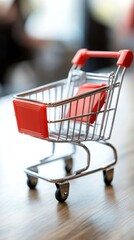 Miniature Shopping Cart on Wooden Surface: A Symbol of Consumerism and Retail
