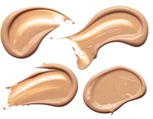 Four light beige foundation smudges, isolated on black