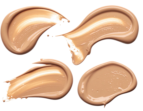 Four light beige foundation smudges, isolated on black