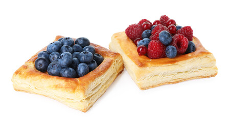 Yummy puff pastries with berries isolated on white
