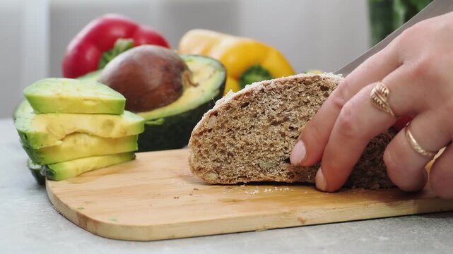 a woman cooks at home salmon and avocado sandwich cottage cheese or soft cheese whole wheat bread. keto diet food. recipe sandwich for the menu. takeaway food. proper nutrition diet for weight loss