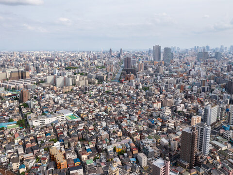 Aerial view of a sprawling cityscape, where tightly packed buildings meet the sky under a soft, diffused light, creating a textured tapestry across the urban landscape, Tokyo, Tokyo, Japan.