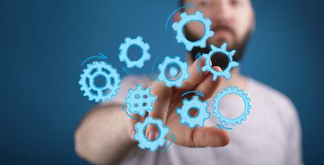 Image of a man interacting with digital gears, symbolizing teamwork, collaboration, and process optimization.