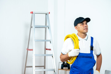 Electrician's Ponder: A skilled electrician pauses with his equipment, focused and contemplative,...
