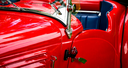 Driver side interior of vintage red convertible car