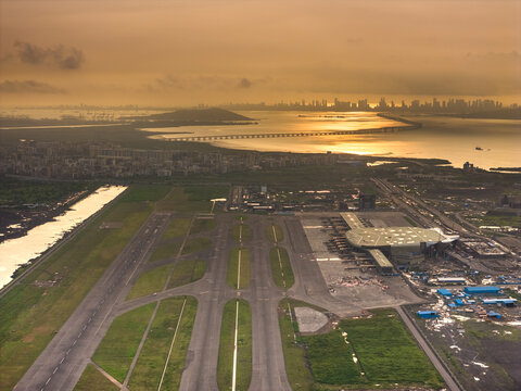 Aerial view of the ongoing construction work of Navi Mumbai International Airport(NMIA), runway, and the terminal building bathed in the warm glow of the sunset, Navi Mumbai, Maharashtra, India.