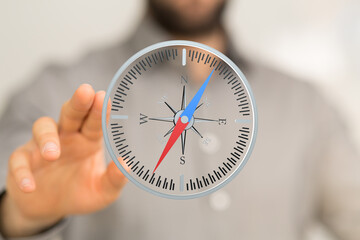 Fototapeta premium Stock photo of a hand interacting with a digital compass, showing direction and guidance.