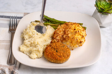  baked cod with crab cakes  and mashed potatoes