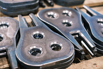 Stacked metal machine parts with circular holes, industrial steel components for manufacturing and mechanical engineering production