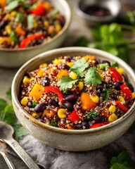 Rainbow quinoa and black bean salad with corn, bell peppers and cilantro