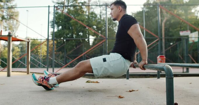 Calisthenics Workout Engaging in Strength Training Utilizing Parallel Bars for Fitness and Health